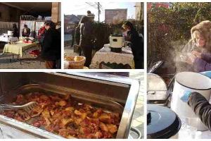 FOTO: O familie de albaiulieni întâmpină în faţa porţii trecătorii veniţi de 1 Decembrie la Alba Iulia, cu fasole şi ciolan preparate în casă, vin fiert şi ceai cald