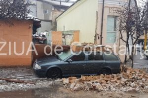 Imagini de la eveniment. Masina avariata pe strada Ștefan Mihaileanu din Constanta. Un gard s-a prabusit peste ea