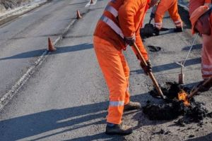 (GALERIE FOTO) România mileniului III. Gropi astupate cu „asfalt la pungă” încălzit la butelie